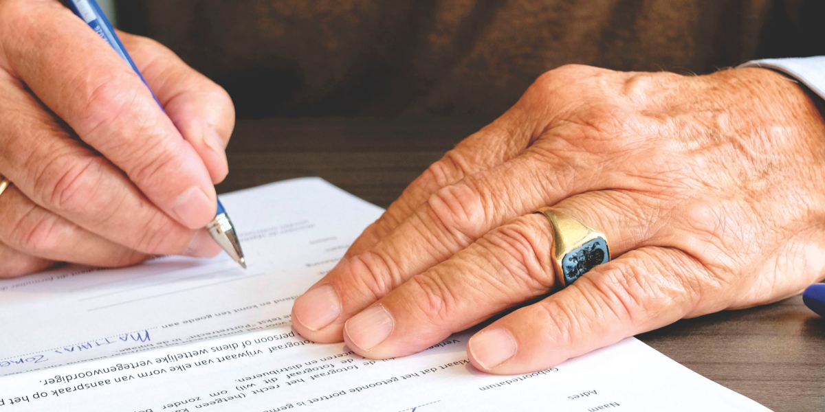 Older Man Signing a Power of Attorney